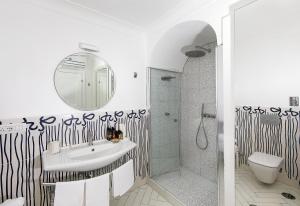 a bathroom with a sink and a shower at Hotel Le Agavi in Positano