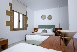 A bed or beds in a room at Agarathos Deluxe Homes - Kaliviani -On the road to Balos