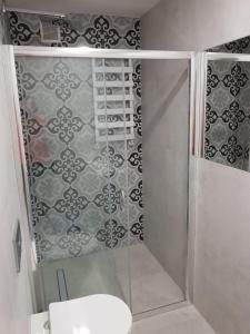 a shower with a glass door in a bathroom at Apartament Monika in Kłodzko