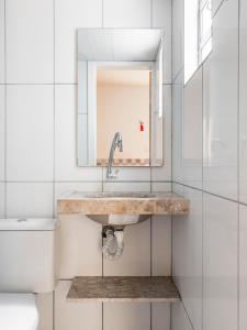 a bathroom with a sink and a toilet at Pousada Veleiro in Fortaleza