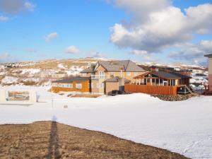 a house with snow on the ground in front at Petit Hotel Corinthian in Rebun