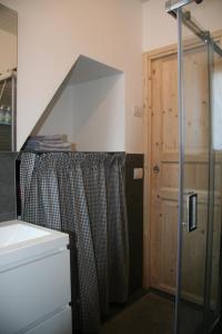 a bathroom with a shower curtain and a sink at nel cuore di Bormio in Bormio