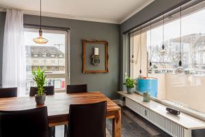 a dining room with a table and a large window at zentrales 130 qm Design-Appartement mit Extras in Karlsruhe