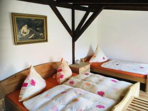 a bedroom with two beds and a picture on the wall at Pension Hainer See - FEWO in Neukieritzsch