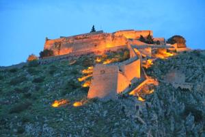 a castle on top of a hill at night at Blue Sky Apartments & Rooms in Xiropigado