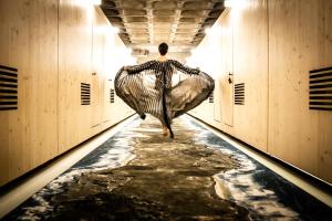 a person walking down a hallway with a large net at Zero Box Lodge Porto in Porto