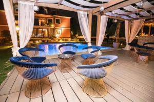 a patio with chairs and a swimming pool at The Belgrade Hills Rooms and Suites in Belgrade