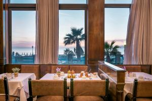 a restaurant with two tables and a view of the ocean at Mitsis La Vita in Rhodes Town