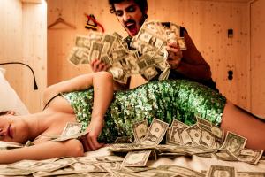 a man and a woman laying on a bed with money at Zero Box Lodge Porto in Porto