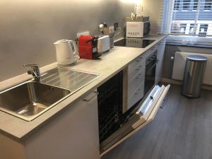 a kitchen with a sink and a counter top at Claire et Liège, toute une histoire... in Liège