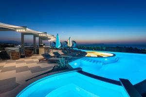 a house with a swimming pool at night at Onira Suite Dreams in Hersonissos