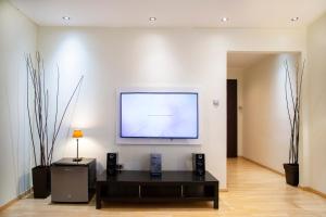 a living room with a large screen on a wall at Athens Best location, 6 Ermou street, Syntagma square in Athens