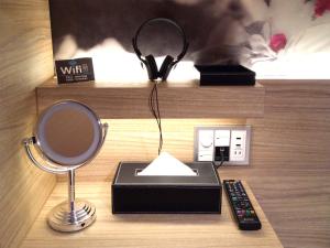 a desk with a mirror and a lamp and a radio at HOTEL Cargo Shinsaibashi in Osaka