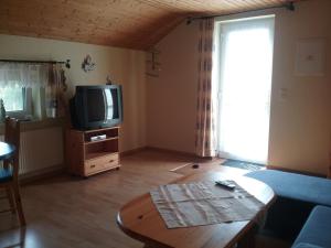 a living room with a tv and a coffee table at Seeidyll in Zemitz