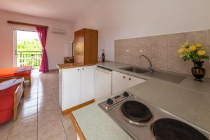 a kitchen with a sink and a counter top at Anthi Studios & Apartments in Alykes