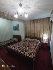 a hotel room with a bed and a window at Silver Hotel in Tashkent