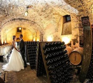 a bride and groom standing in a wine cellar at Villa Redona in Entratico