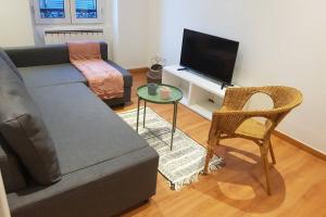 a living room with a couch and a television at Cosy home near Paris in Gagny