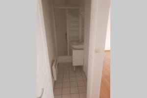 a white bathroom with a sink and a toilet at Cosy home near Paris in Gagny +7 photos