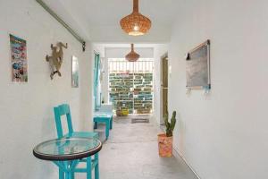 a room with a table and two chairs and a table at Casa Cálido Hotel in Cozumel