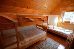 a bedroom with two bunk beds in a cabin at Apartmaji Zupančič in Bohinj