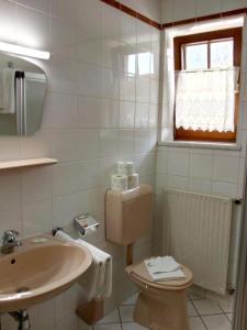 Baño blanco con aseo y lavamanos en vidimo se en Selzthal