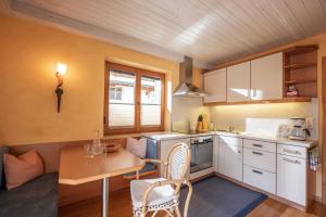 a kitchen with a table and a dining room at Haus Sieglinde in Finkenberg