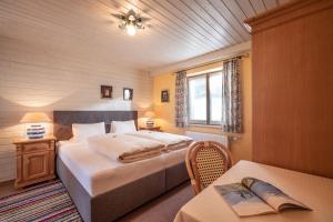 a bedroom with a bed and a table and a window at Haus Sieglinde in Finkenberg