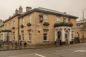 a brick building on the side of a street at Norfolk Arms in Glossop