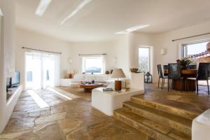a living room with a couch and a table at Zen Residence in Lia beach in Kalafatis
