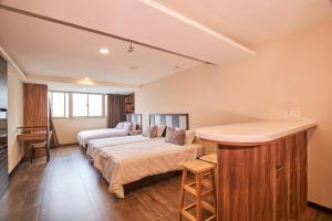 Postel nebo postele na pokoji v ubytování Greeninn Hotel