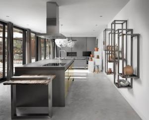 a kitchen with a large sink and a staircase at Stalen Boshuis in Oosterhout