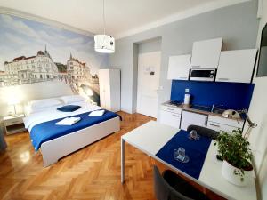 a bedroom with a king sized bed and a kitchen at B&B Vila Teslova in Ljubljana