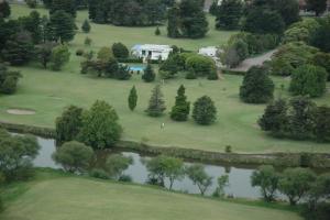 an aerial view of a golf course with a pond at Depto en La Vicente! in Olavarría