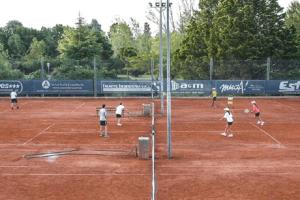 a group of people playing tennis on a tennis court at Depto en La Vicente! in Olavarría