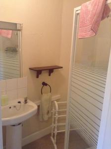 a bathroom with a sink and a shower at Park House Guest House in Warwick