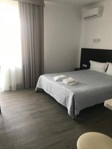Postel nebo postele na pokoji v ubytování Neopolis