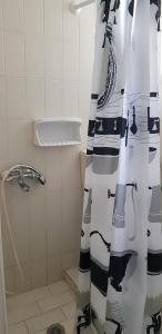 a shower curtain in a bathroom with a shower at Cascade Holiday Resort in Poros