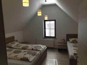 a bedroom with two beds and a window at Apartmaji Kramar Rateče in Kranjska Gora