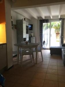a kitchen and living room with a table and chairs at ANGLET- BIARRITZ T3 dans résidence avec piscine in Anglet