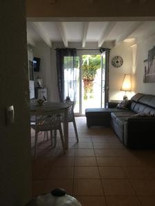 a living room with a couch and a table at ANGLET- BIARRITZ T3 dans résidence avec piscine in Anglet +17 photos
