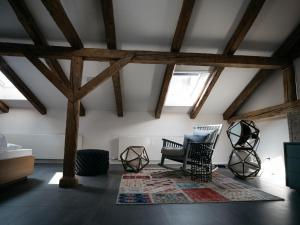 a room with wooden beams and a chair and a rug at artHotel Blaue Gans in Salzburg