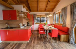 a kitchen and dining room in a tiny house at Chalet Waldhof in Flattach +32 photos