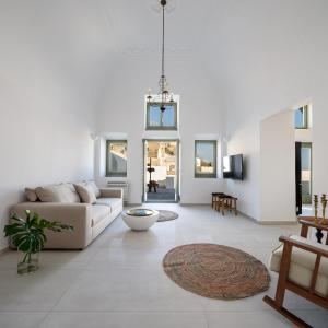 a living room with a couch and a rug at VILLA DI CAPO - Santorini Old Winery Luxury Villas in Akrotiri