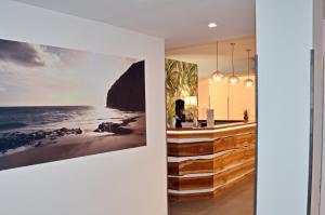 a bar in a house with a picture on the wall at Sobrado Boutique Hotel in Santa Maria