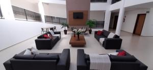 a living room with couches and a coffee table at Guines Palace Hotel in Patrocínio