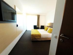En eller flere senge i et værelse på Zenith - Top Country Line - Conference & Spa Hotel