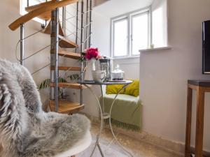 a living room with a chair and a table at Bothy in Bibury