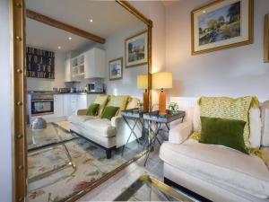 a living room with two couches and a table at Bothy in Bibury