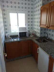 Kuchyň nebo kuchyňský kout v ubytování Apartamento en edificio Stella Maris
